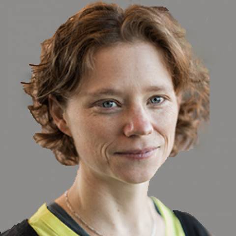 woman with short, curly auburn hair