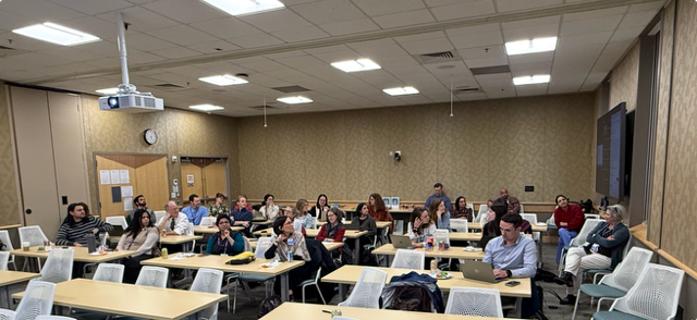Group of people watching presentation